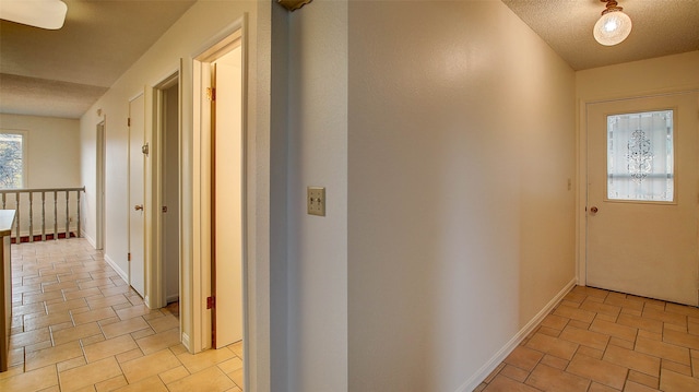 hall with a textured ceiling