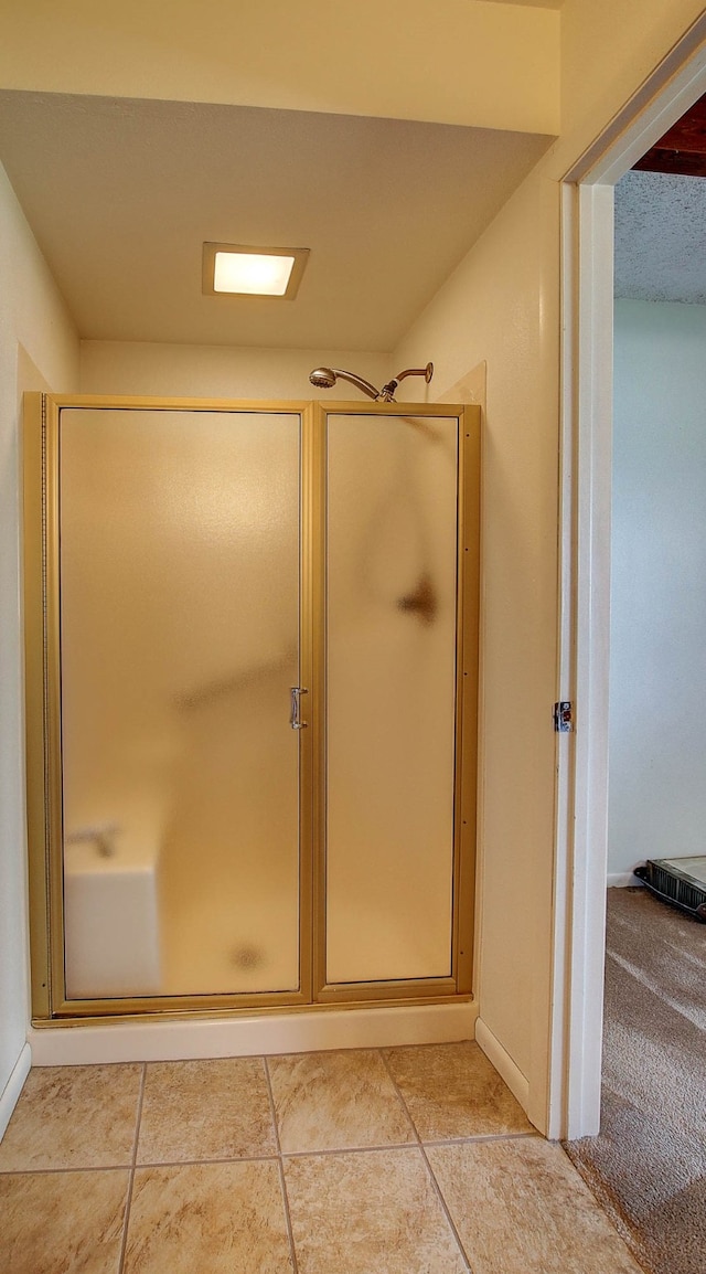 bathroom featuring a shower with door and tile patterned floors