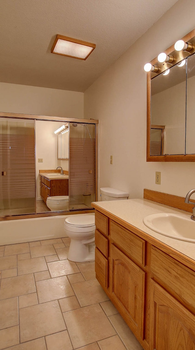 full bathroom with toilet, enclosed tub / shower combo, vanity, and a textured ceiling