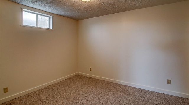 spare room with carpet and a textured ceiling