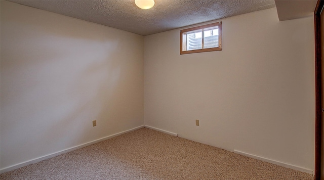 carpeted spare room featuring a textured ceiling