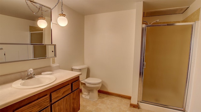 bathroom with a shower with door, toilet, and vanity