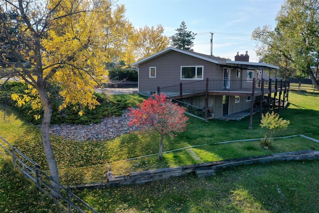 rear view of house with a deck and a lawn