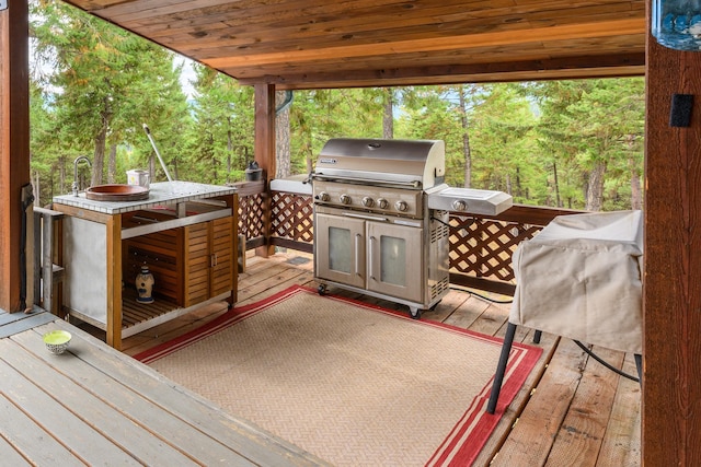 view of patio / terrace with grilling area and a wooden deck