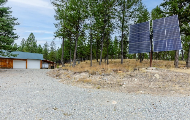 exterior space featuring a garage and an outbuilding