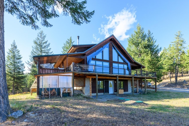 rear view of property with a wooden deck