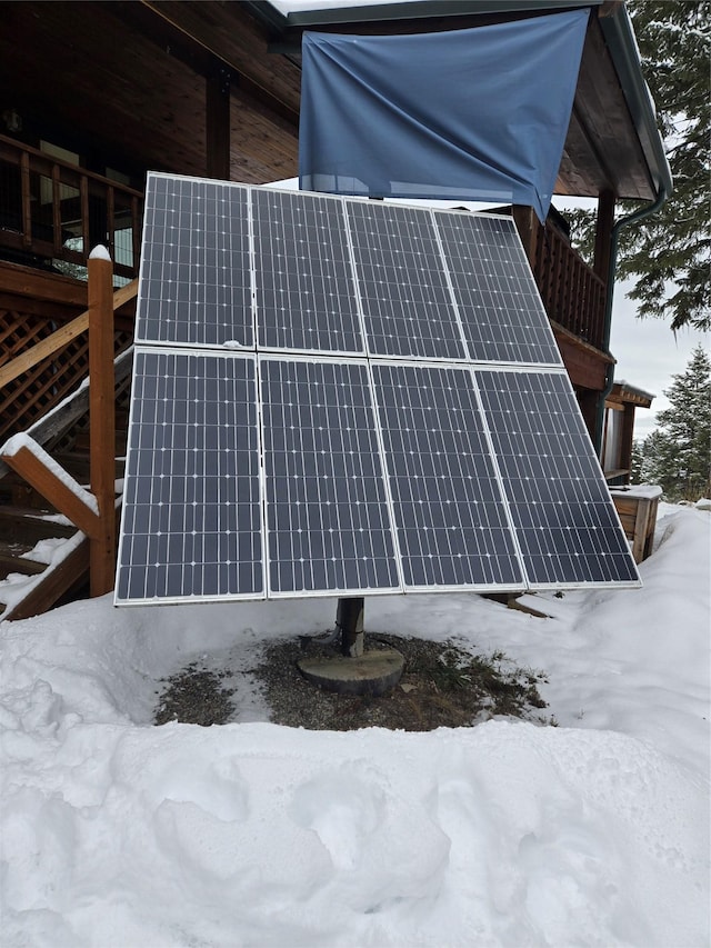 snow covered property featuring solar panels