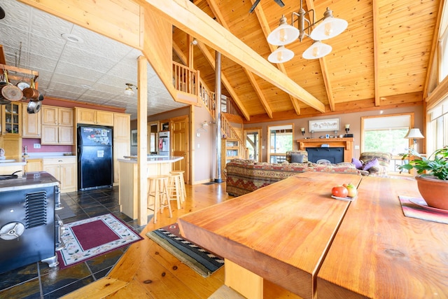 dining area featuring beamed ceiling, a notable chandelier, wood ceiling, and high vaulted ceiling