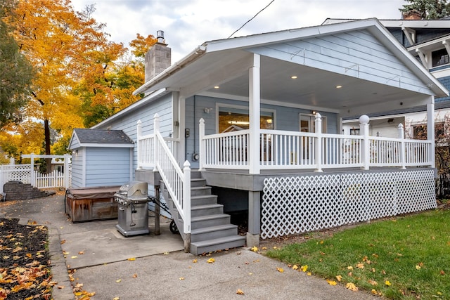 back of property featuring a hot tub