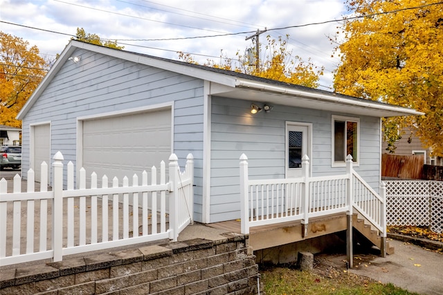 exterior space featuring a garage and an outdoor structure