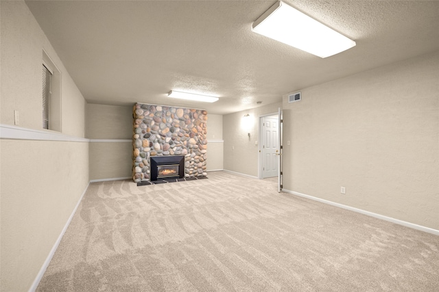 basement featuring a textured ceiling and light carpet