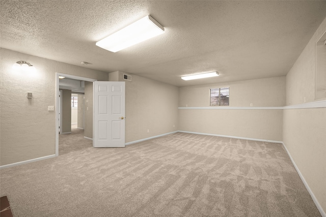 basement with carpet floors and a textured ceiling