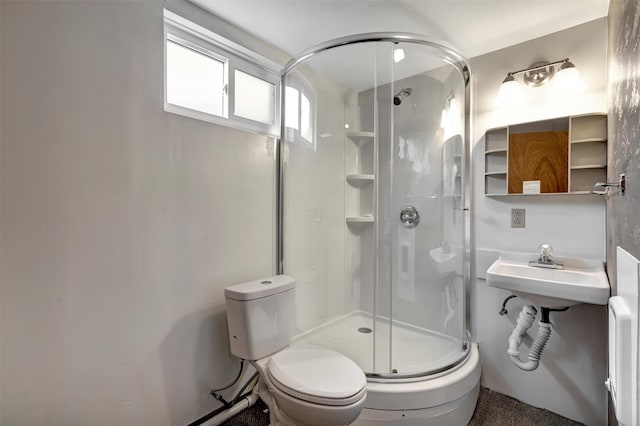 bathroom featuring toilet and walk in shower