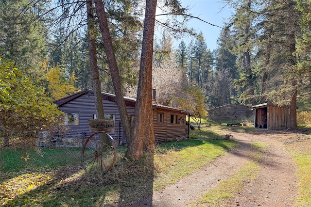 view of side of property featuring a storage unit