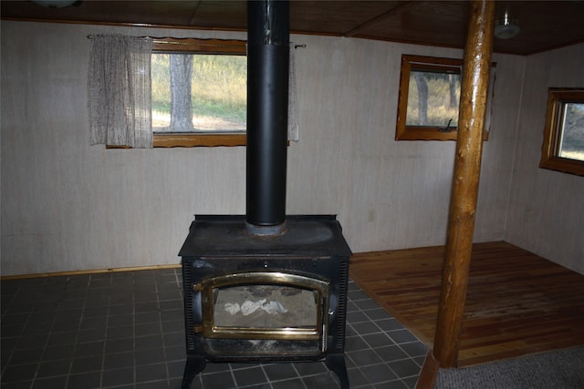 details with a wood stove and tile patterned floors