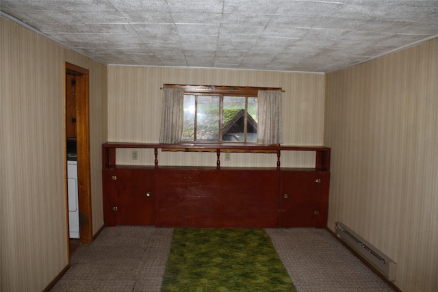 empty room featuring washer / dryer, carpet, and baseboard heating