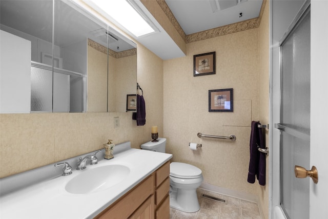 bathroom featuring a shower with door, toilet, tile patterned floors, and vanity