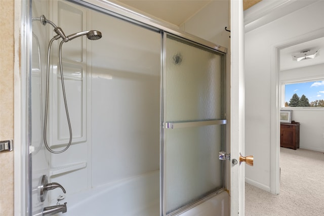 bathroom featuring bath / shower combo with glass door