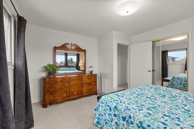 bedroom with multiple windows and a closet