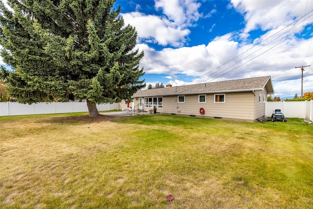 back of property with a patio area and a lawn