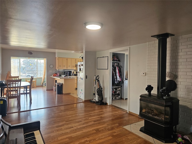 living room featuring a wood stove and wood-type flooring