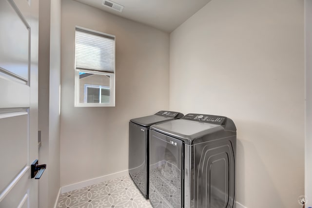 washroom featuring light tile patterned floors and separate washer and dryer