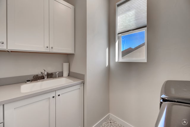 interior space featuring independent washer and dryer, cabinets, and sink