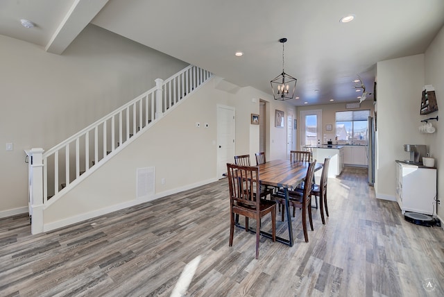 dining room featuring a chandelier and light wood-type flooring