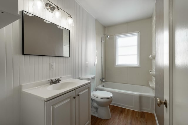 full bathroom featuring wood-type flooring, toilet, shower / bathing tub combination, and vanity