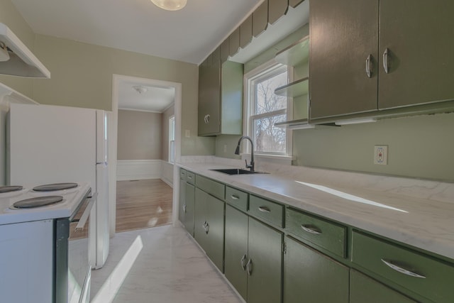 kitchen featuring sink, electric range, ventilation hood, and green cabinetry