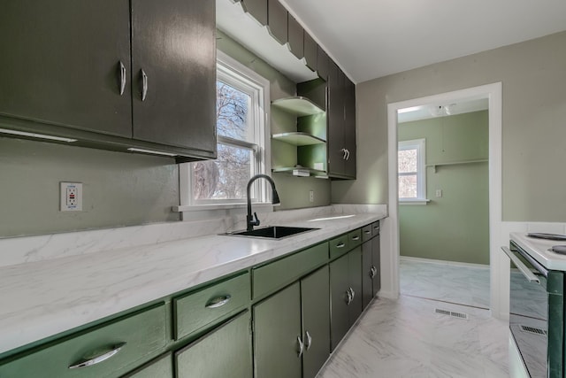 kitchen featuring green cabinets, white electric range oven, light stone countertops, and sink