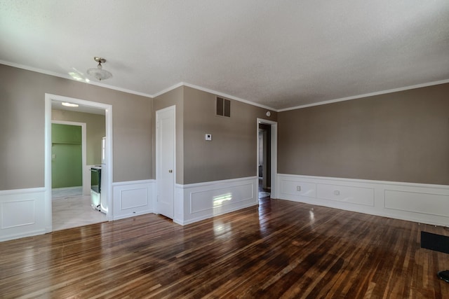 spare room featuring hardwood / wood-style flooring and crown molding