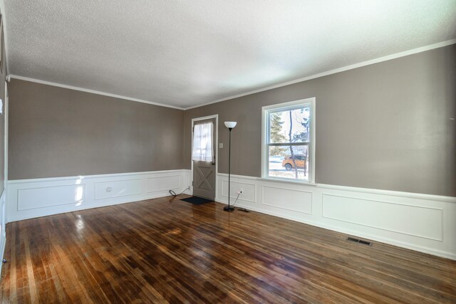 empty room with dark wood-type flooring and ornamental molding