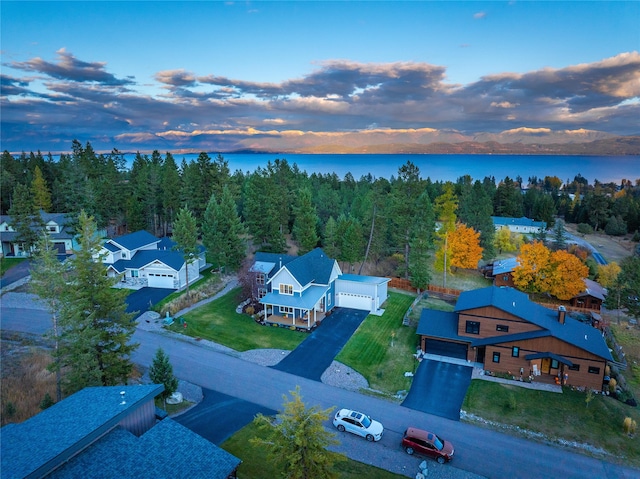 aerial view at dusk with a water view