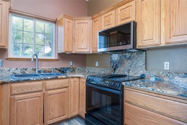 kitchen featuring decorative backsplash, light brown cabinets, sink, stone counters, and black range with electric stovetop