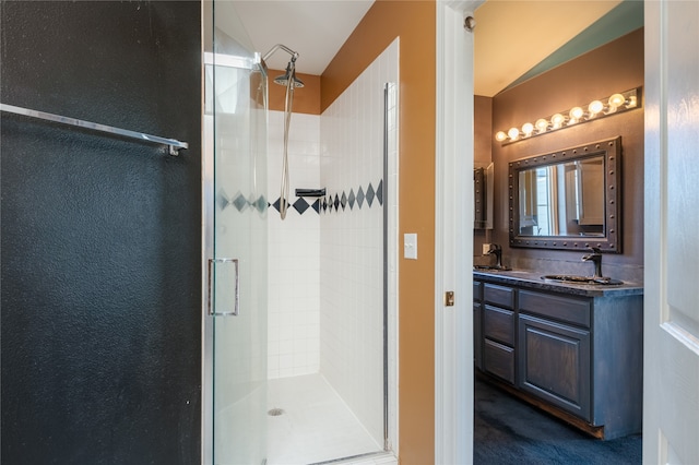 bathroom featuring vanity and an enclosed shower