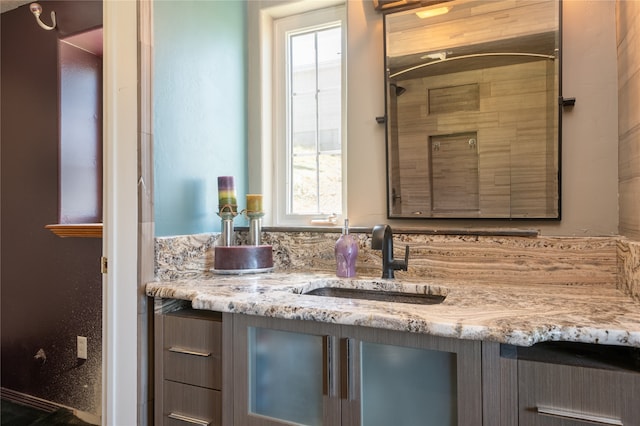 bathroom featuring vanity and tiled shower