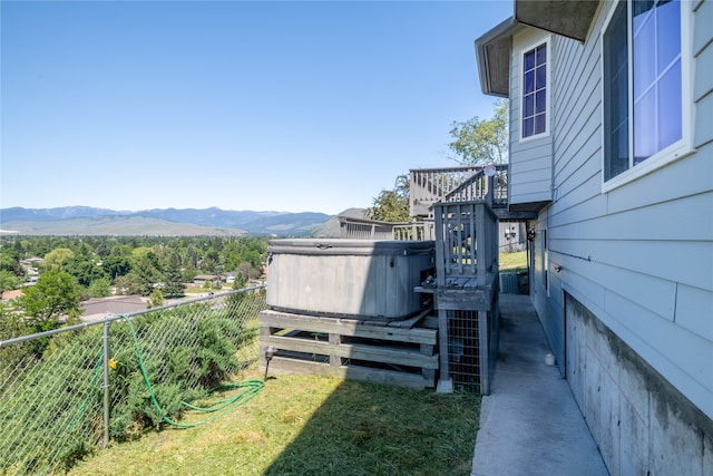 view of yard featuring a hot tub and a mountain view