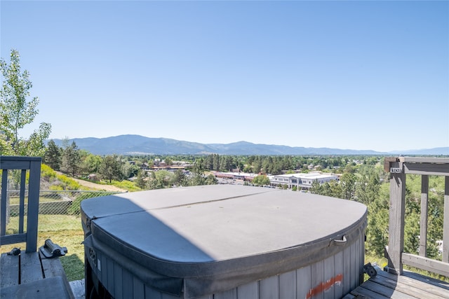 exterior space with a hot tub and a mountain view