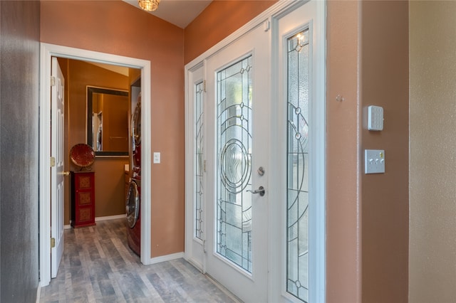 doorway to outside featuring washer / dryer and hardwood / wood-style floors