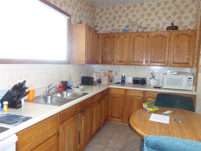 kitchen featuring sink and light tile patterned floors