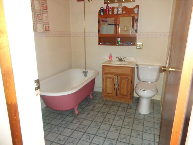 bathroom with vanity, toilet, and a bathing tub