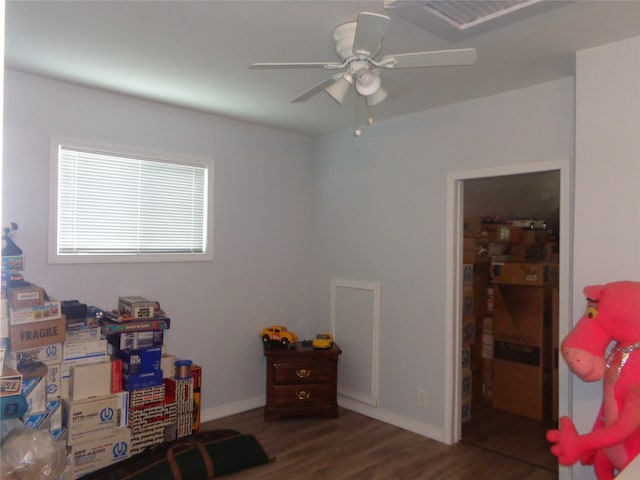 recreation room with dark wood-type flooring and ceiling fan