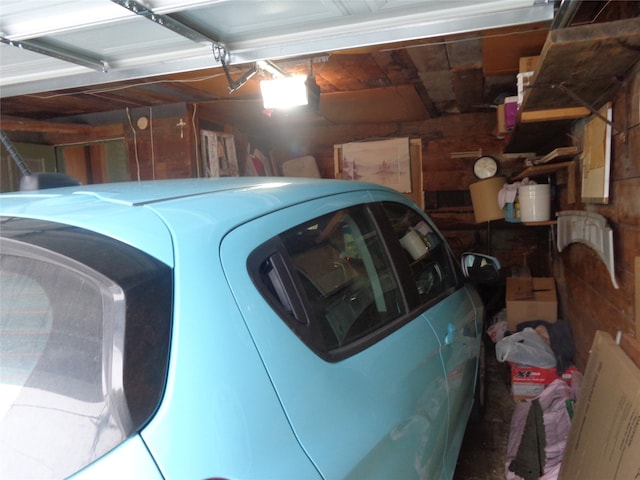 garage featuring wood walls