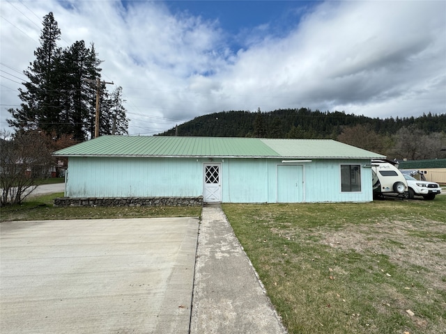 view of outbuilding with a lawn