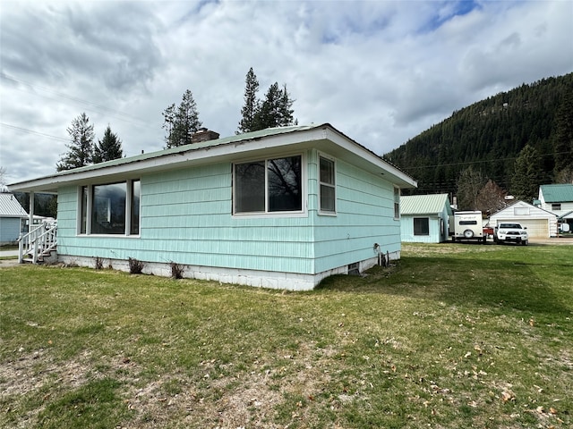 view of side of home featuring a lawn