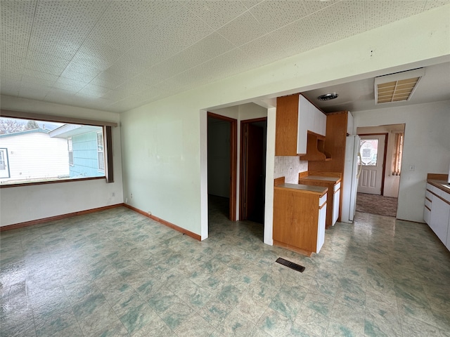 kitchen featuring backsplash and white refrigerator