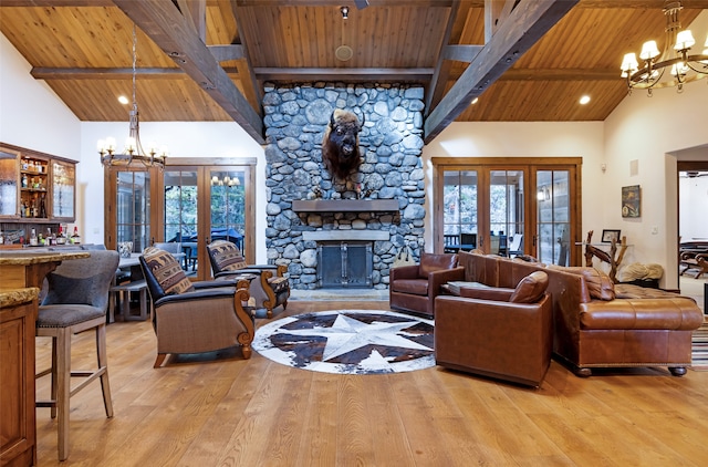 living room featuring french doors, wooden ceiling, and light wood-type flooring