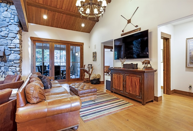 living room featuring light wood-type flooring, ceiling fan with notable chandelier, french doors, wooden ceiling, and high vaulted ceiling