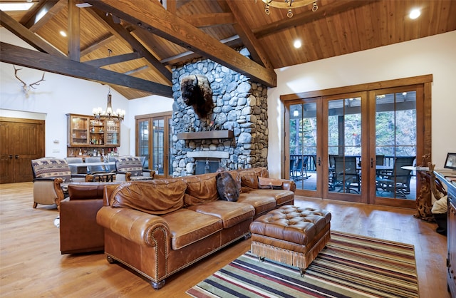 living room with light hardwood / wood-style floors, an inviting chandelier, high vaulted ceiling, and wooden ceiling